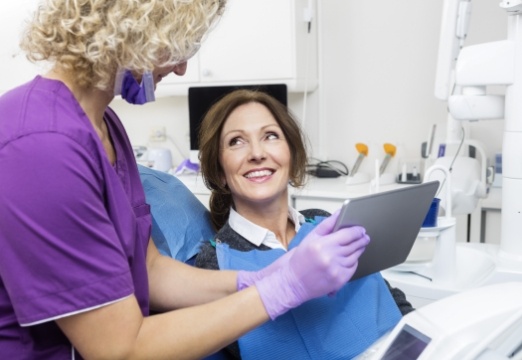Woman and dentist discussing emergency dentistry treatment