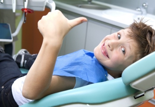 Young dentistry patient smiling during children's dental checkups and teeth cleanings