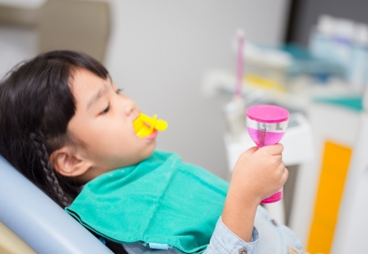 Child receiving fluoride treatment