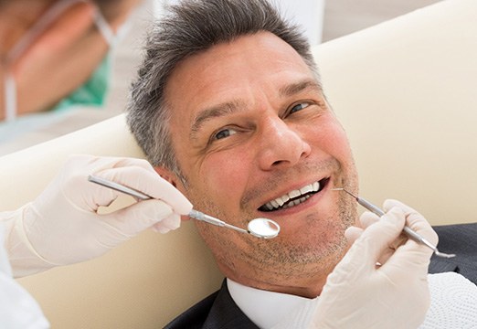 Man smiling at dentist in Glenmont