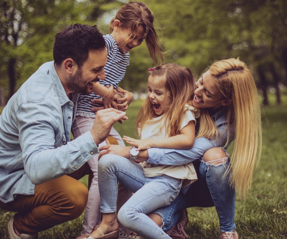 Family of four with healthy smiles after visiting their dentist in Glenmont New York