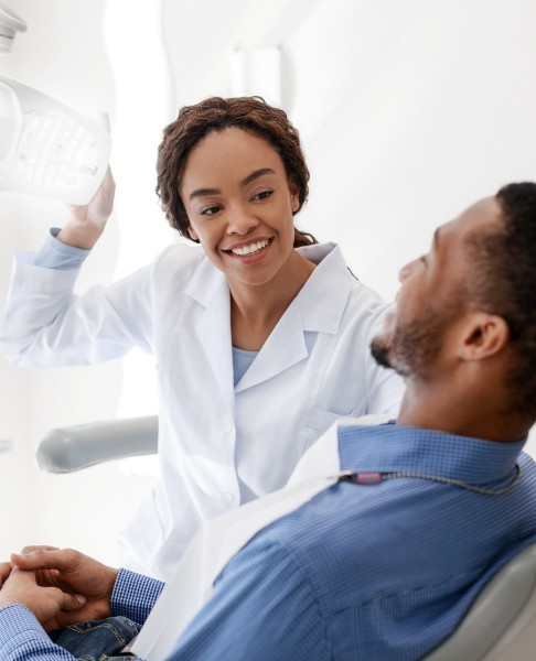 Dentist talking to patient during first dental office visit