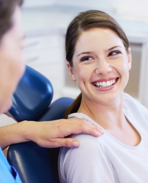 Woman smiling during dental office visit