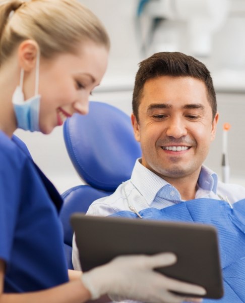 Dentist and dental patient looking at digital x-rays during exam