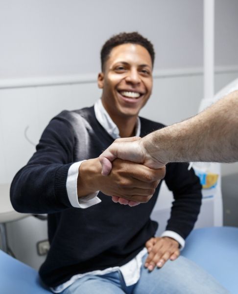 Dentist and patient shaking hands
