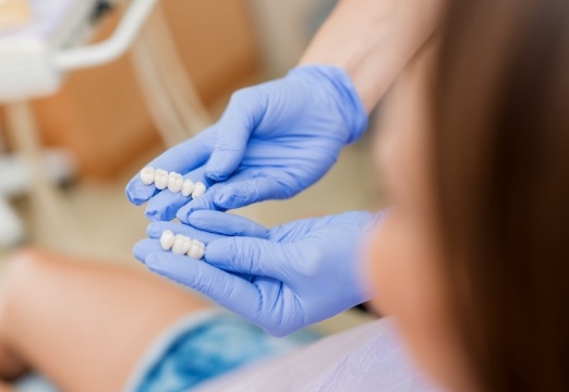 Dentist showing dental patient dental bridges